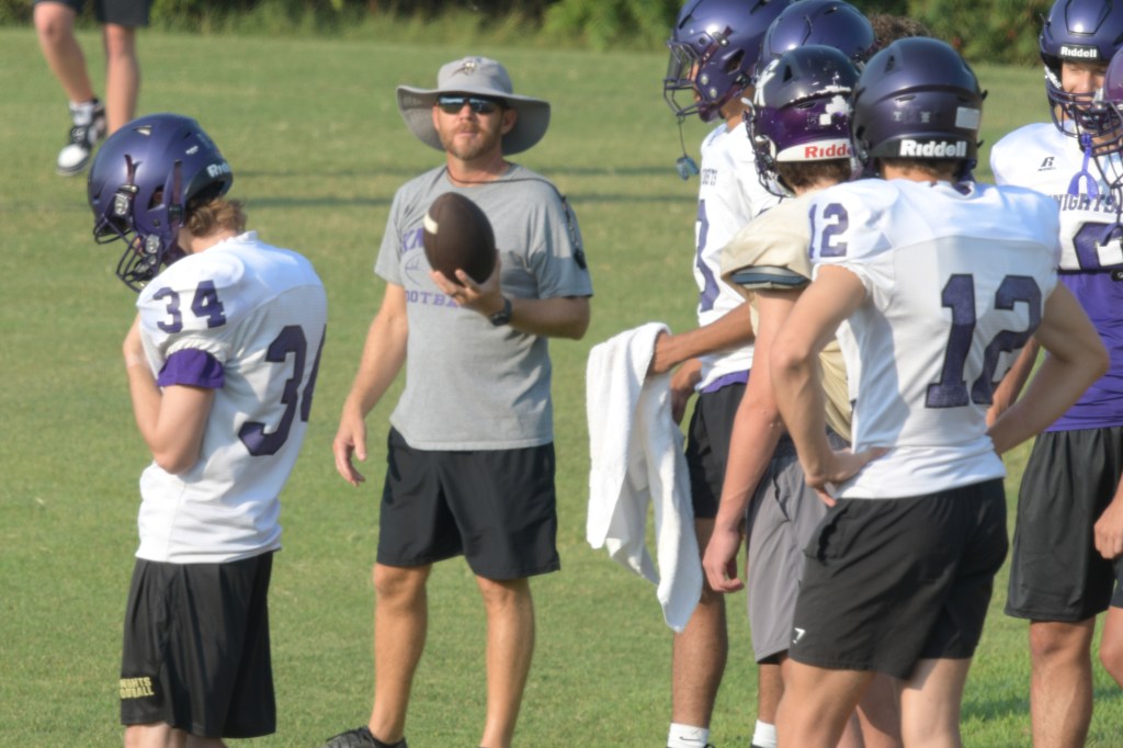 Coach John Harless working with receivers during practice on Friday, Aug. 7.