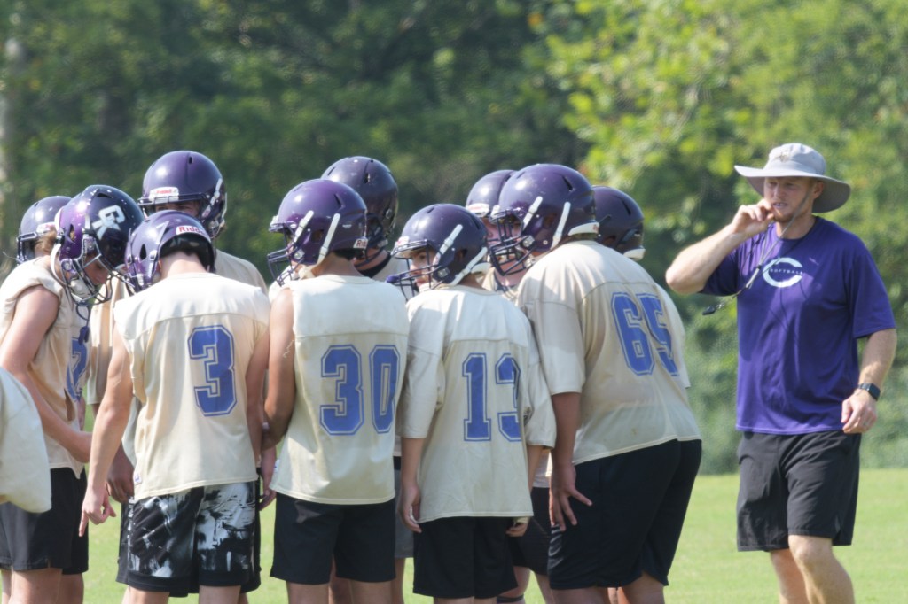 Coach Russell Watts works with the junior high team on Friday, Aug. 7.