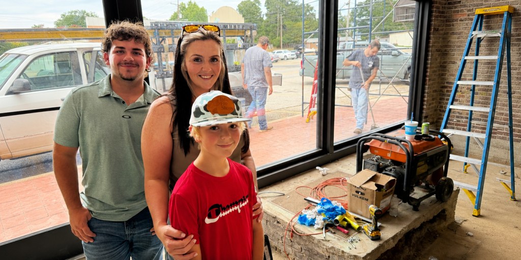 Downtown Soapery proprietor Tasha Harris and her sons Braxton, left, and Jacob Harris inside the renovated storefront soon after windows were installed. Photo: Michael Hibblen
