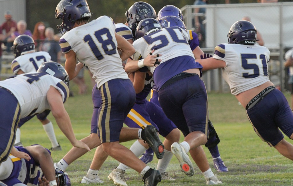 Running back Ely Welch tries to find a hole in the Panther defense. Blocking on the play for Welch are (L to R) Leo Hamilton, Parker Bailey and Zaden Allen. All photos: Paul Shepard