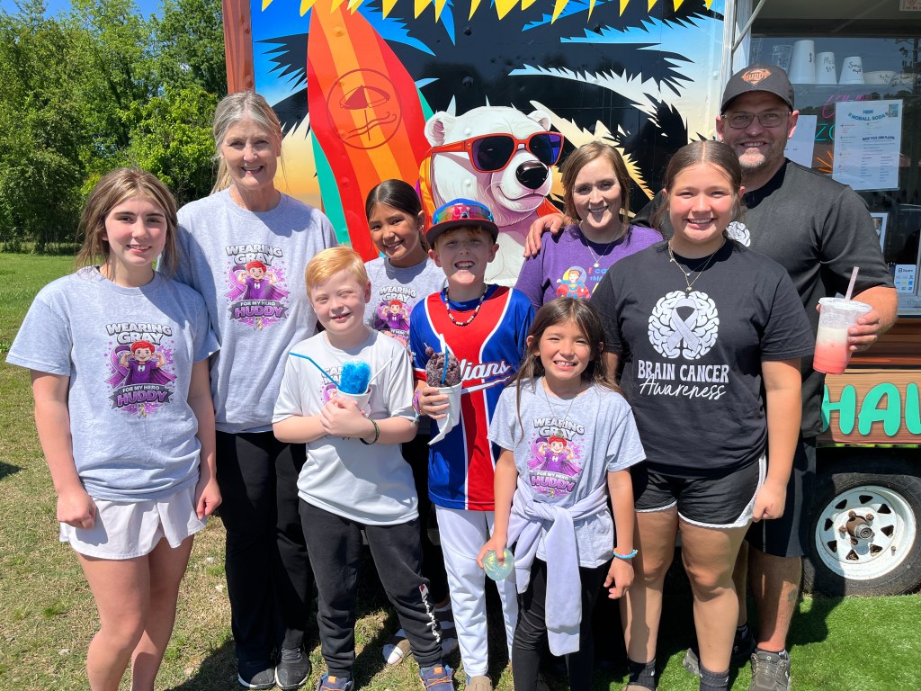 Hudson Ty Simmons, third from left, with family and friends during a snow cone fundraiser in Glenwood on May 8. Photos: Michael Hibblen